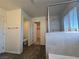 Bright bathroom featuring a modern shower with tiled walls and wood-look flooring at 5817 Bonita Rose St, Las Vegas, NV 89113