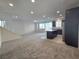 Large living room with a staircase and open to the kitchen, with stainless steel appliances and ample natural light at 5817 Bonita Rose St, Las Vegas, NV 89113
