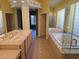 Bright bathroom featuring double vanities, large mirrors, soaking tub, and walk-in shower with glass block window at 601 Summer Mesa Dr, Las Vegas, NV 89144