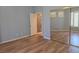 Neutral bedroom with hardwood floors, mirrored closet doors and views of the backyard at 601 Summer Mesa Dr, Las Vegas, NV 89144
