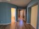 Bedroom features hardwood floors, neutral walls, and archways to adjacent rooms at 601 Summer Mesa Dr, Las Vegas, NV 89144