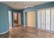 Large bedroom featuring modern ceiling fan, wood floors, and plantation shutters at 601 Summer Mesa Dr, Las Vegas, NV 89144