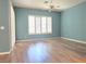 Bedroom featuring modern ceiling fan, wood floors, and plantation shutters at 601 Summer Mesa Dr, Las Vegas, NV 89144