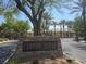 Community entrance with stone Canyon Ridge sign surrounded by mature trees and lush greenery on a bright day at 601 Summer Mesa Dr, Las Vegas, NV 89144