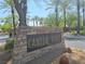 Elegant stone sign for Canyon Ridge community, with palm trees dotting the landscape on a bright sunny day at 601 Summer Mesa Dr, Las Vegas, NV 89144