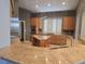 Beautiful kitchen featuring granite counters, stainless appliances and central island at 601 Summer Mesa Dr, Las Vegas, NV 89144