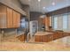 Updated kitchen with granite counters, wood cabinets, stainless appliances and an island at 601 Summer Mesa Dr, Las Vegas, NV 89144