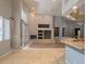 Spacious living room with fireplace, tile floors, and access to the kitchen at 601 Summer Mesa Dr, Las Vegas, NV 89144
