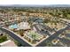 Community aerial view showcasing the pool, clubhouse, bocce ball, tennis courts, and desert landscaping at 6114 Saddle Horse Ave, Las Vegas, NV 89122