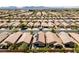 An aerial view captures a neighborhood with uniformly styled homes and neatly arranged landscaping at 6114 Saddle Horse Ave, Las Vegas, NV 89122