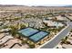 Expansive aerial view of a residential community with mountain views and recreational amenities at 6114 Saddle Horse Ave, Las Vegas, NV 89122