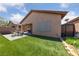Well-maintained backyard with artificial turf and covered patio area at 6114 Saddle Horse Ave, Las Vegas, NV 89122