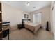 Well-lit bedroom with a desk, closet, and neutral carpeting at 6114 Saddle Horse Ave, Las Vegas, NV 89122