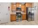 Functional kitchen with stainless steel appliances, wood cabinetry, and a clean, well-lit space at 6114 Saddle Horse Ave, Las Vegas, NV 89122