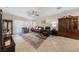 Spacious living room featuring tile flooring, comfortable seating, and natural light from large windows at 6114 Saddle Horse Ave, Las Vegas, NV 89122