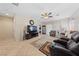 Bright living room offering ample space with tile floors, large windows, and cozy furniture at 6114 Saddle Horse Ave, Las Vegas, NV 89122