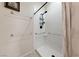 Modern walk-in shower featuring safety bars, a rainfall shower head, and neutral accents at 6114 Saddle Horse Ave, Las Vegas, NV 89122