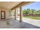Spacious covered patio with concrete flooring and support columns, overlooking a well-maintained backyard at 6821 Sleepy Pine St, Las Vegas, NV 89130
