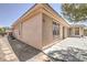Beige stucco home featuring stone walkway and manicured landscaping at 6821 Sleepy Pine St, Las Vegas, NV 89130