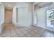Foyer area with tiled flooring, natural light, and white door at 6821 Sleepy Pine St, Las Vegas, NV 89130