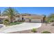 Charming single-story home with a three-car garage, desert landscaping, and a well-maintained lawn at 6821 Sleepy Pine St, Las Vegas, NV 89130