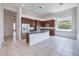 Gourmet kitchen with stainless steel appliances, dark wood cabinets and center island at 6821 Sleepy Pine St, Las Vegas, NV 89130