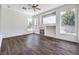 Bright living room with wood floors, large windows, and a fireplace with tile surround at 6821 Sleepy Pine St, Las Vegas, NV 89130