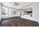 Open living room with wood floors, large windows, and an open transition to the kitchen at 6821 Sleepy Pine St, Las Vegas, NV 89130