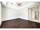 Living room with wood flooring, a tray ceiling, and an open entrance to a hallway at 6821 Sleepy Pine St, Las Vegas, NV 89130