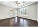 Living room with wood floors, large windows with backyard views, and a glass patio door at 6821 Sleepy Pine St, Las Vegas, NV 89130