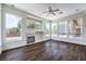 Spacious living room with a fireplace, wood floors, and views of the landscaped backyard at 6821 Sleepy Pine St, Las Vegas, NV 89130