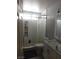 Modest bathroom features a shower with a white curtain and a vanity with a faux marble countertop at 7542 Mycroft Ct, Las Vegas, NV 89147