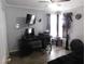 Bright office space with a desk, television, and comfortable seating area at 7542 Mycroft Ct, Las Vegas, NV 89147