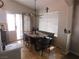 Cozy dining area with a modern light fixture, a dining table, and a sliding glass door providing natural light at 7542 Mycroft Ct, Las Vegas, NV 89147