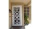 Close-up of the home's entryway, showcasing a decorative security door and a well-maintained facade at 7542 Mycroft Ct, Las Vegas, NV 89147