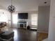 Bright living area featuring wood floors, contemporary lighting, and views into the dining area at 7542 Mycroft Ct, Las Vegas, NV 89147