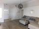 View of a bright living room with hardwood floors, a gray sectional sofa, and modern decor at 7542 Mycroft Ct, Las Vegas, NV 89147