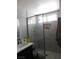 Contemporary bathroom with a glass-enclosed shower and stone-look tile, providing a spa-like feel at 7542 Mycroft Ct, Las Vegas, NV 89147