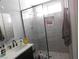 Modern bathroom with a sleek glass shower enclosure and a built-in niche for toiletries at 7542 Mycroft Ct, Las Vegas, NV 89147