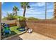 Backyard featuring green umbrella, artificial turf, and block wall at 7706 Crystal Village Ln, Las Vegas, NV 89113