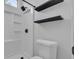 Clean-lined bathroom with a shower, black shelves, and a standard white toilet at 7706 Crystal Village Ln, Las Vegas, NV 89113