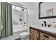 Clean bathroom with shower-tub combo, neutral walls, and a wood vanity at 7706 Crystal Village Ln, Las Vegas, NV 89113