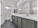 Bathroom featuring a double sink vanity, with a shower and lots of storage space at 7706 Crystal Village Ln, Las Vegas, NV 89113