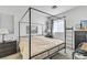 Bright bedroom with a king bed, dark wood dresser, and a ladder decor piece at 7706 Crystal Village Ln, Las Vegas, NV 89113