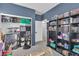 Cozy bedroom featuring blue walls, carpet, and a closet full of toys and books at 7706 Crystal Village Ln, Las Vegas, NV 89113