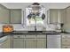 Updated kitchen with stone countertops, stainless steel appliances, and hanging pot rack at 7706 Crystal Village Ln, Las Vegas, NV 89113