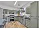 Stylish kitchen featuring stainless steel appliances, wood floors, and subway tile backsplash at 7706 Crystal Village Ln, Las Vegas, NV 89113
