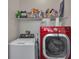 Laundry room with red front load washer and white top load dryer at 7706 Crystal Village Ln, Las Vegas, NV 89113