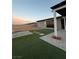 Nice backyard with artificial turf, pavers, and covered patio ideal for outdoor living at 7966 W Ford Ave, Las Vegas, NV 89113
