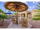 Spacious backyard with inviting seating area, lounge chairs, desert landscaping and mature palms at 8209 Chapelle Ct, Las Vegas, NV 89131